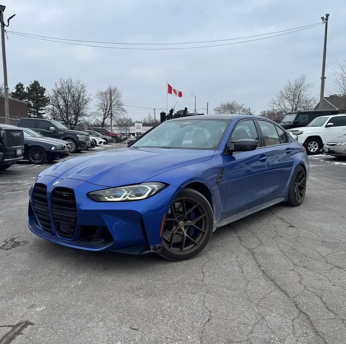 A blue BMW M3 sedan
