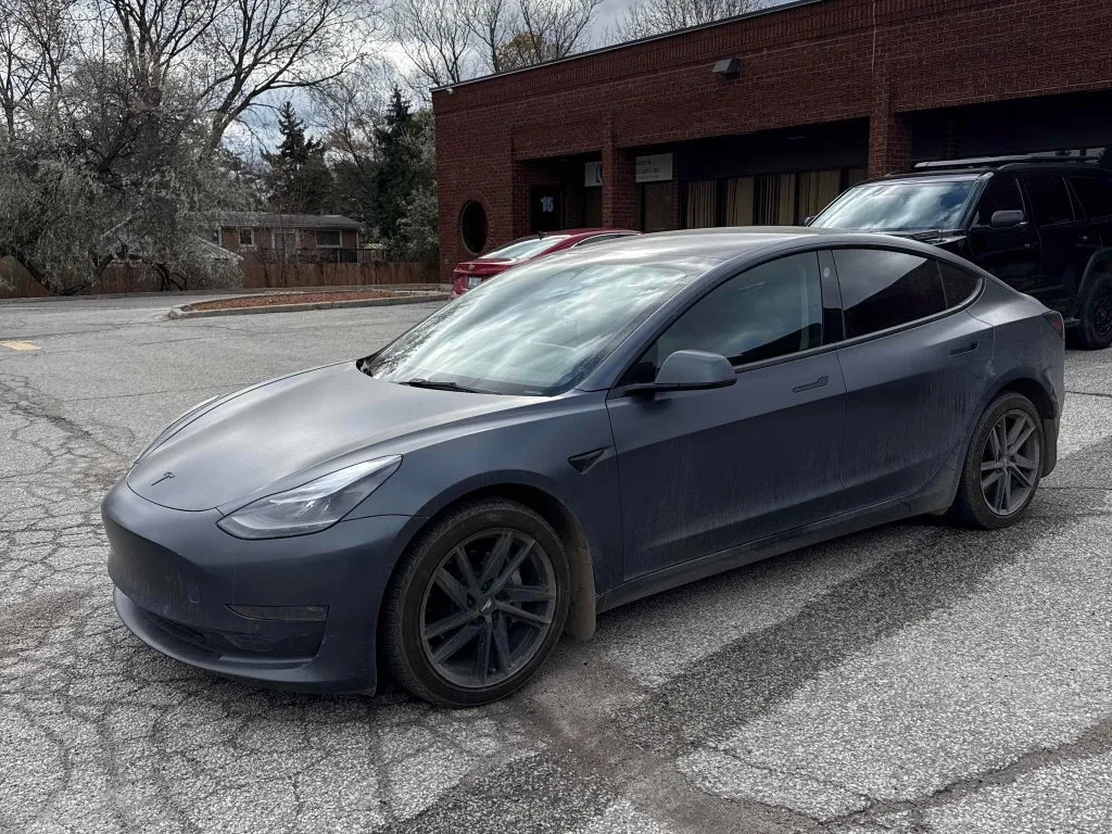 A dark gray Tesla Model 3